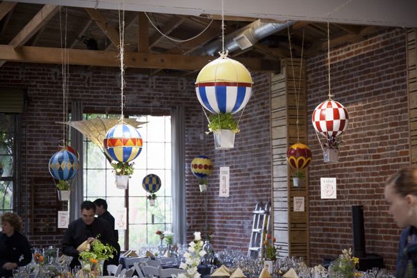 Hanging miniature hot air balloons at a wedding reception
