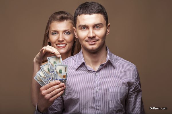 Fashion beautiful couple in love holding money the family budget