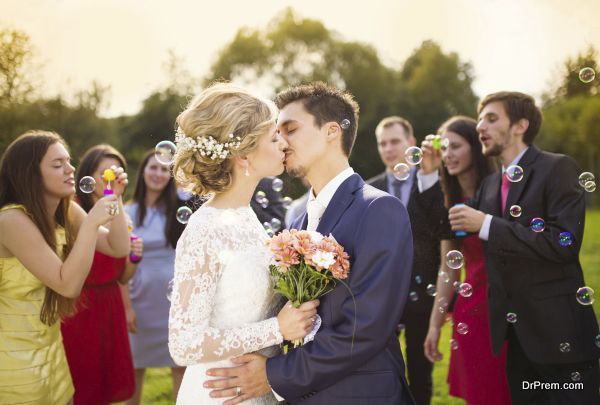 Newlyweds kissing at wedding reception