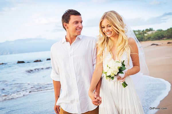 Bride and Groom Walking on Beautiful Tropical Beach at Sunset