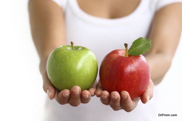 Hands holding red and green apples