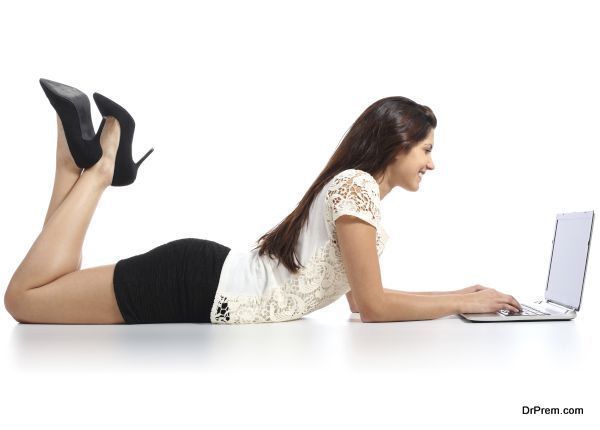 Sexy woman lying working with a laptop
