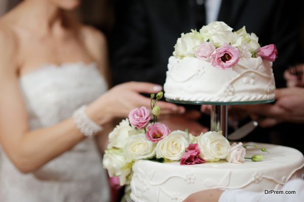 Bride And Groom Cutting Cake