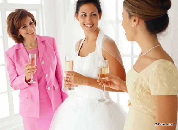 portrait of a bride her mother and the bridesmaid drinking champagne