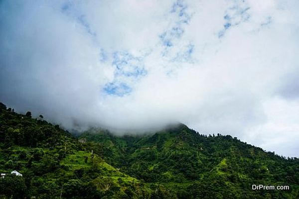 clouds rolling over the green hills of shimla